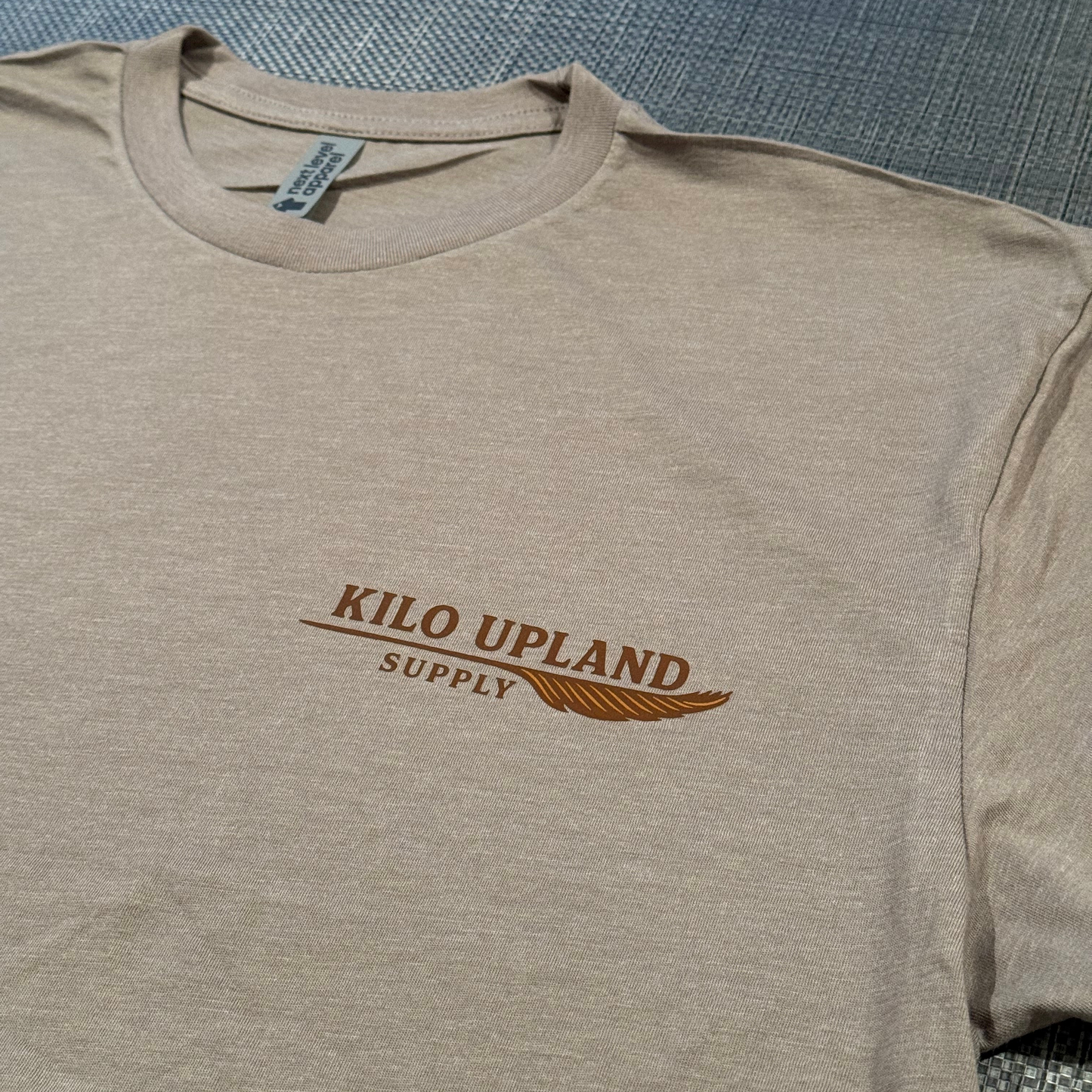 Stone colored Kilo Upland Supply T-Shirt.